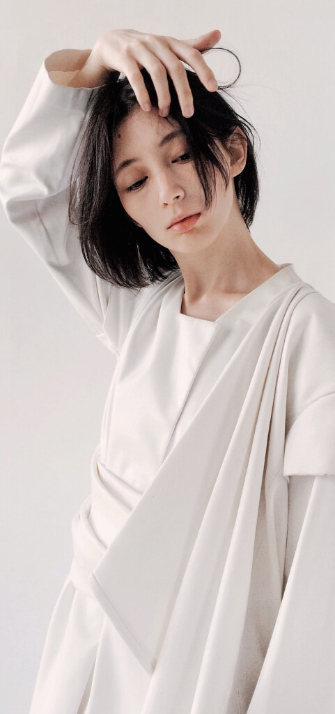 high-fashion female model in ivory suit design